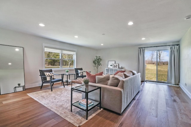 living room with recessed lighting, baseboards, and wood finished floors