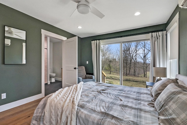 bedroom with a ceiling fan, wood finished floors, baseboards, ensuite bath, and access to exterior