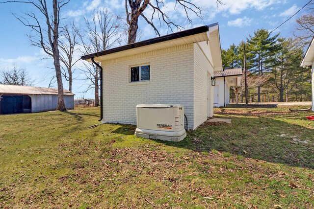 view of side of home with a lawn and brick siding