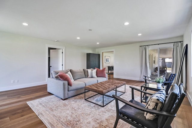 living area with recessed lighting, baseboards, and wood finished floors