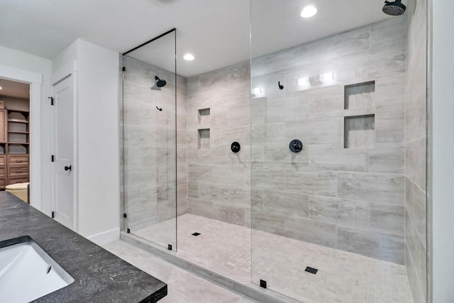 bathroom with a shower stall, recessed lighting, and a sink