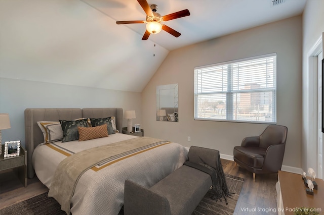 bedroom with visible vents, a ceiling fan, wood finished floors, baseboards, and vaulted ceiling