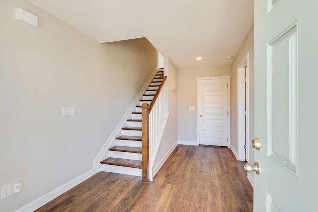 foyer entrance with stairway, recessed lighting, baseboards, and wood finished floors