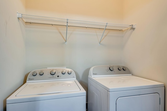 clothes washing area featuring washer and dryer and laundry area
