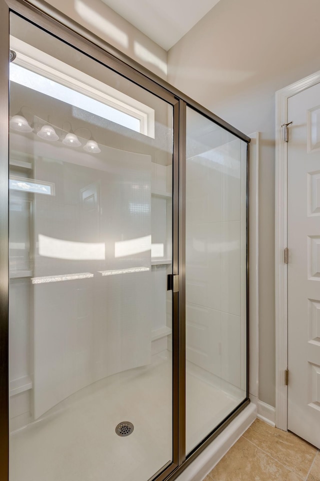 bathroom with tile patterned floors and a stall shower