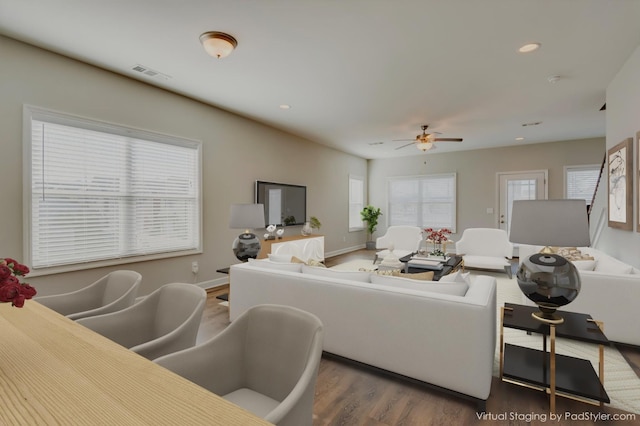 living room featuring visible vents, baseboards, ceiling fan, recessed lighting, and wood finished floors
