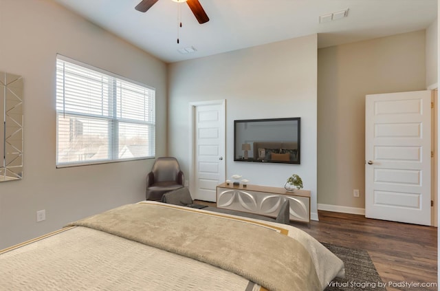 bedroom featuring visible vents, ceiling fan, baseboards, and wood finished floors