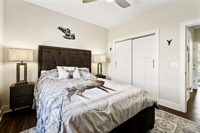 bedroom with dark wood-style flooring, a closet, baseboards, and a ceiling fan