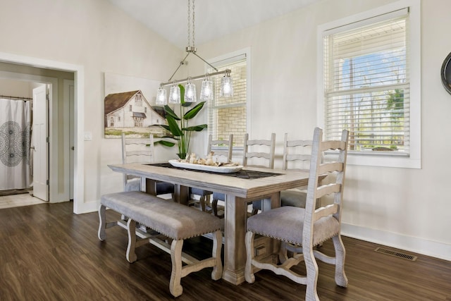 dining room featuring visible vents, baseboards, wood finished floors, and a healthy amount of sunlight
