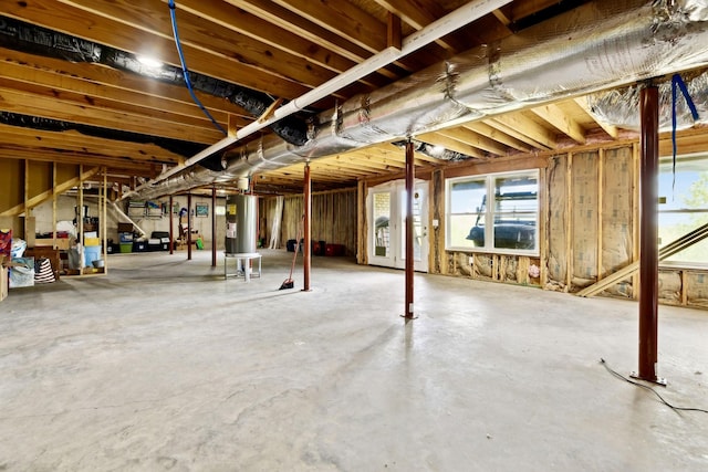 below grade area featuring plenty of natural light and water heater