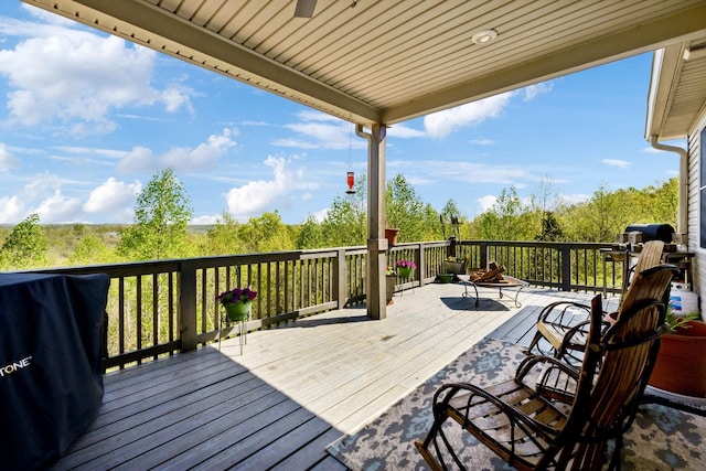 wooden deck with an outdoor fire pit