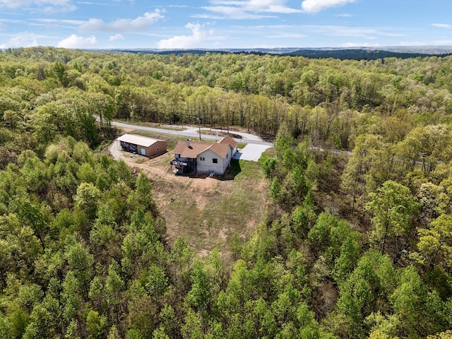 drone / aerial view featuring a forest view