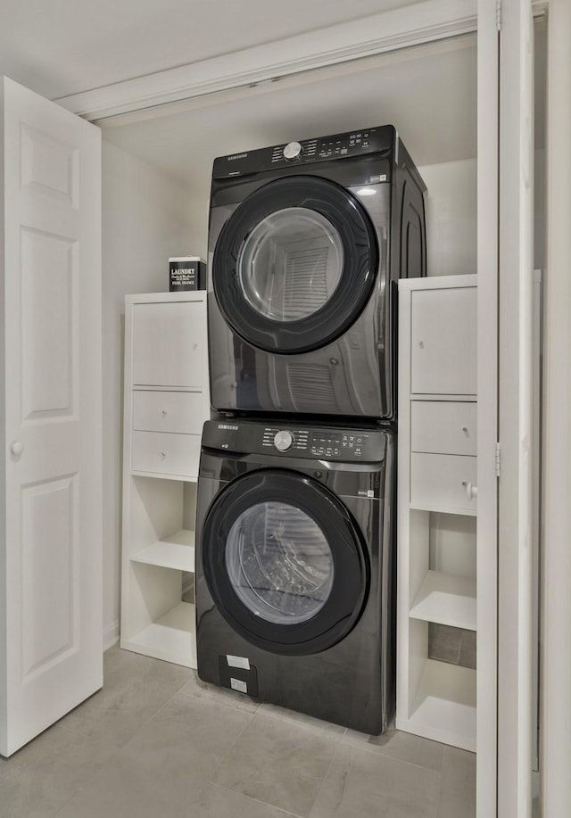 laundry room featuring stacked washer / dryer and laundry area