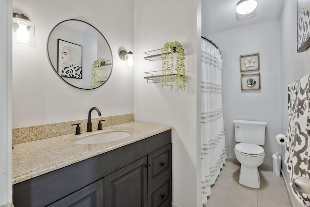 bathroom featuring vanity, tile patterned floors, and toilet