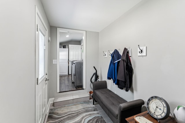 mudroom featuring plenty of natural light, independent washer and dryer, and wood finished floors