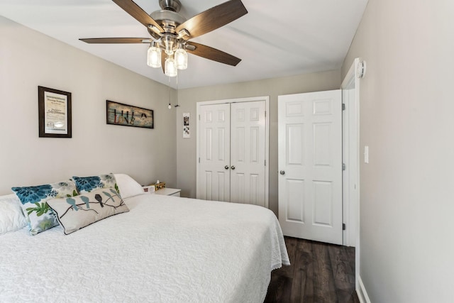 bedroom featuring a closet, dark wood-style flooring, ceiling fan, and baseboards