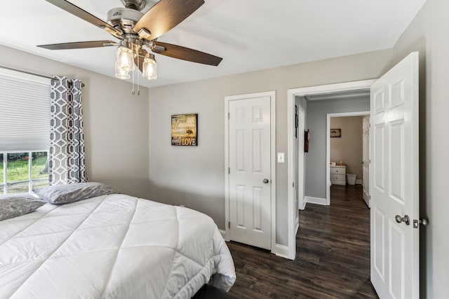 bedroom featuring baseboards, dark wood-style floors, and a ceiling fan