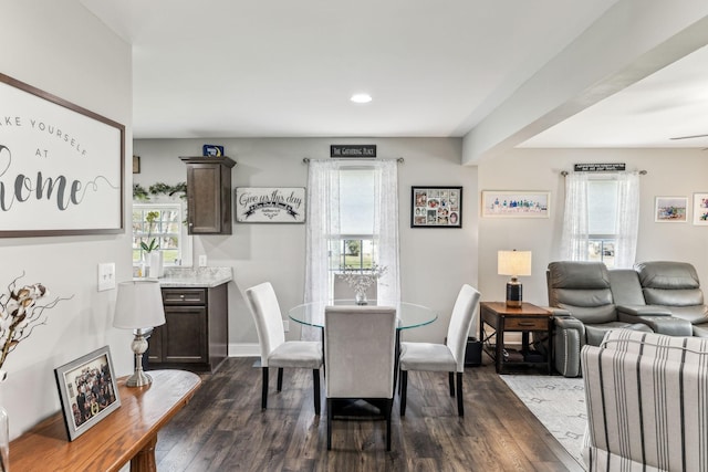 dining space with dark wood finished floors, baseboards, and recessed lighting