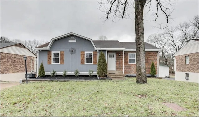 ranch-style house featuring brick siding and a front lawn