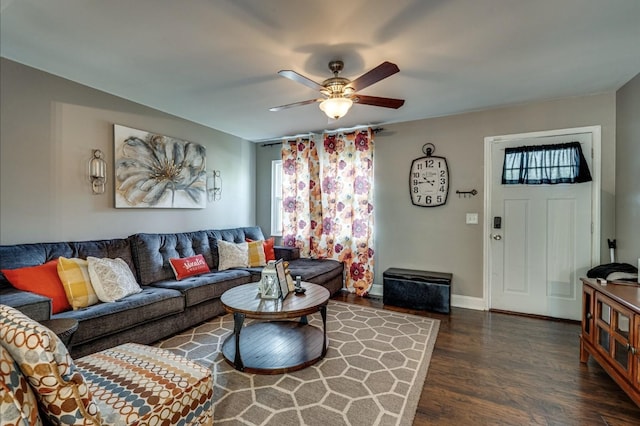 living room with baseboards, a ceiling fan, and wood finished floors