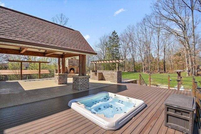 wooden terrace with hot tub deck surround and a warm lit fireplace
