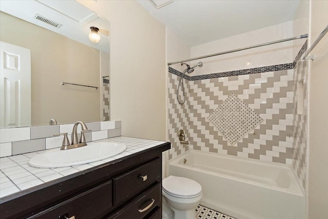 bathroom featuring visible vents, vanity, toilet, and bathing tub / shower combination