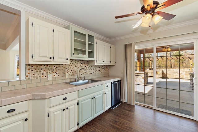 kitchen with a sink, ornamental molding, decorative backsplash, and stainless steel dishwasher