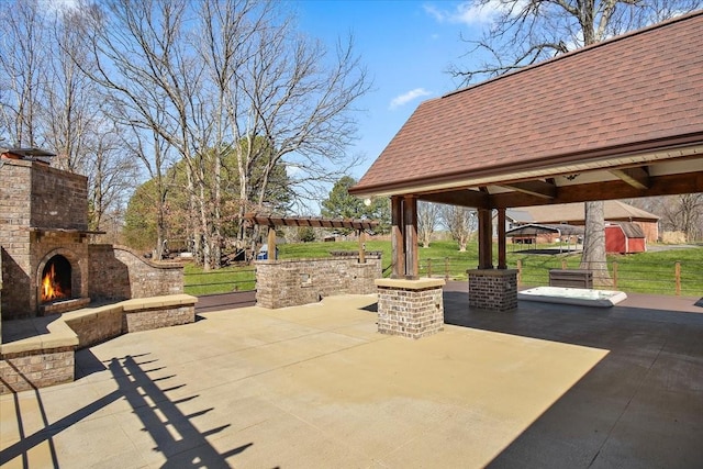 view of patio / terrace featuring a gazebo, a pergola, and an outdoor brick fireplace