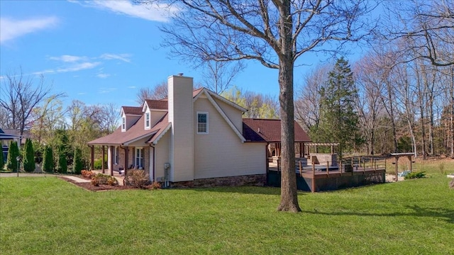 view of side of property with a lawn, a chimney, a deck, and a pergola