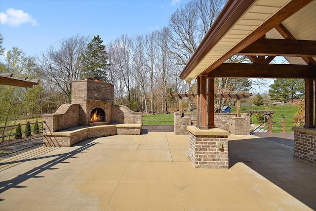 view of patio / terrace with a gazebo and an outdoor brick fireplace