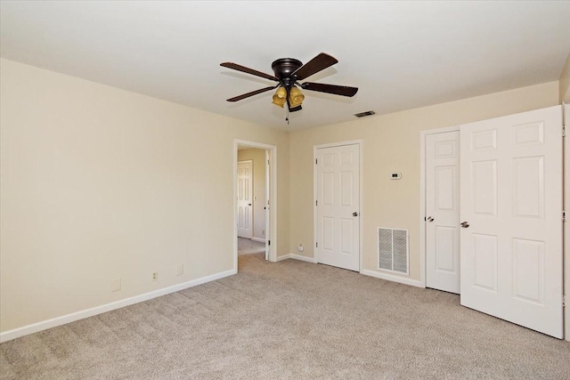 unfurnished bedroom with a ceiling fan, baseboards, visible vents, and light carpet