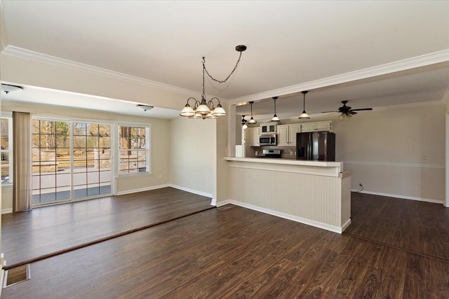 unfurnished dining area with dark wood-style floors, crown molding, and ceiling fan with notable chandelier