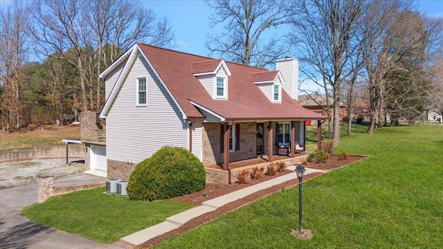 view of home's exterior featuring aphalt driveway, roof with shingles, covered porch, a garage, and a yard