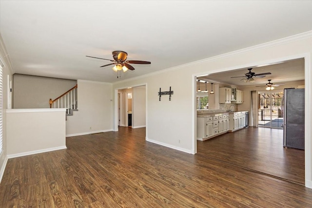 unfurnished living room with baseboards, ceiling fan, dark wood-style flooring, and ornamental molding