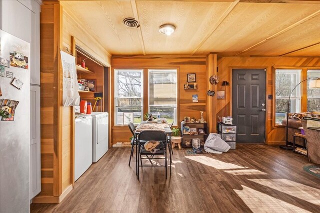 112 Shasteen St, Estill Springs, TN 37330 - dining area with washer and clothes dryer, visible vents, wood finished floors, and wood walls