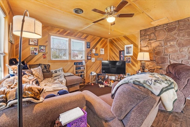 112 Shasteen St, Estill Springs, TN 37330 - living room with visible vents, wooden walls, and a ceiling fan
