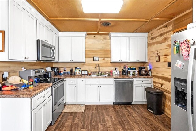 112 Shasteen St, Estill Springs, TN 37330 - kitchen featuring a sink, appliances with stainless steel finishes, and wooden walls