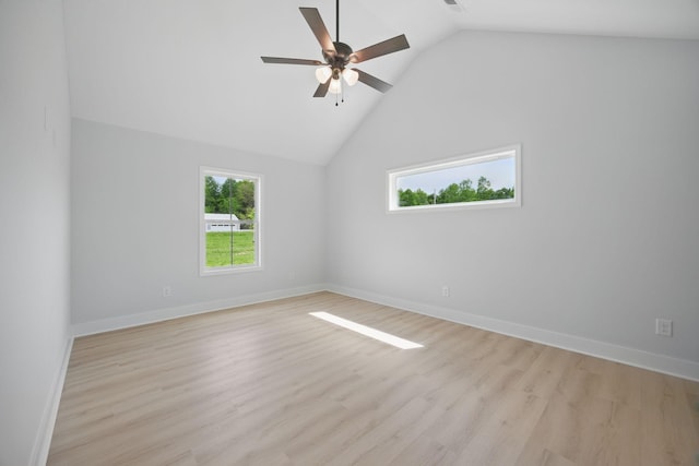 empty room with a healthy amount of sunlight, baseboards, a ceiling fan, and light wood-type flooring