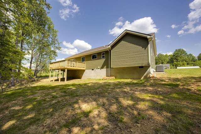rear view of house featuring central air condition unit and a wooden deck