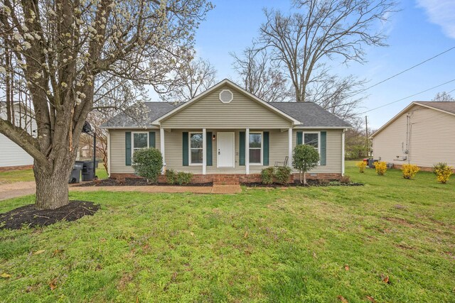 view of front of house with a porch, a front lawn, and a shingled roof