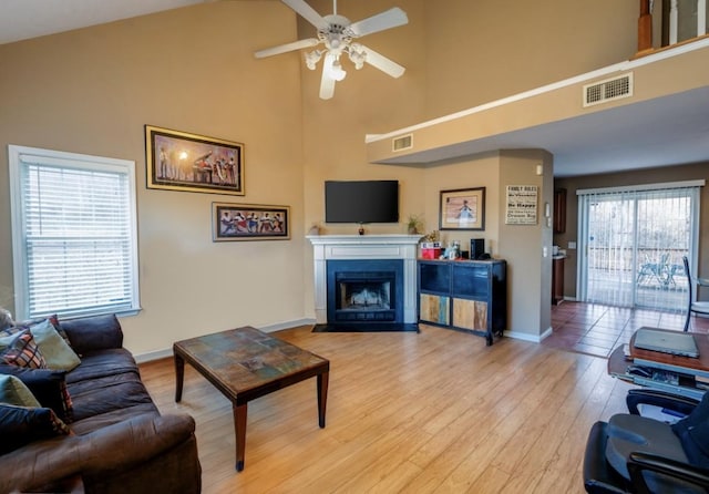 4241 Kevinwood Ct, Antioch, TN 37013 - living area featuring high vaulted ceiling, a ceiling fan, light wood-style flooring, and a fireplace with flush hearth