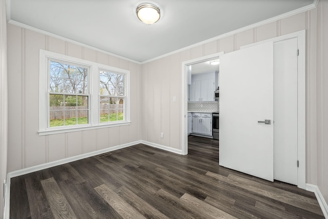 unfurnished bedroom featuring crown molding, visible vents, dark wood-style flooring, and baseboards