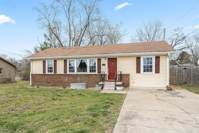 view of front of home with brick siding, driveway, a front yard, and fence