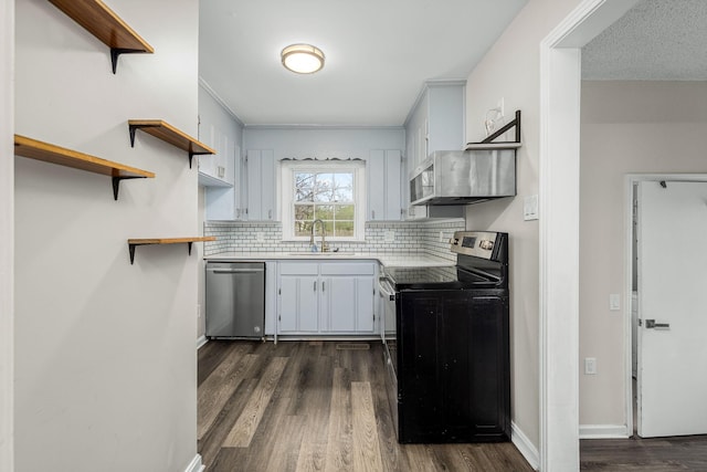kitchen with a sink, open shelves, appliances with stainless steel finishes, and light countertops
