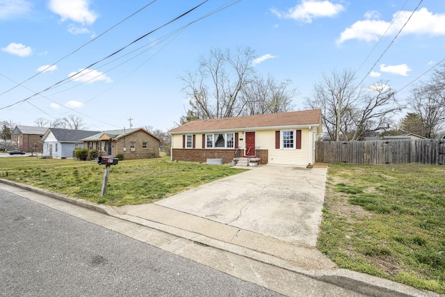 view of front of property featuring brick siding, driveway, a front yard, and fence