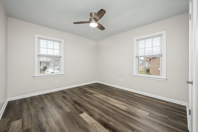 spare room featuring plenty of natural light, baseboards, and a ceiling fan
