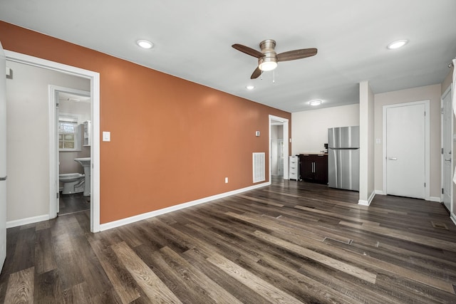 unfurnished living room with visible vents, baseboards, ceiling fan, and dark wood finished floors
