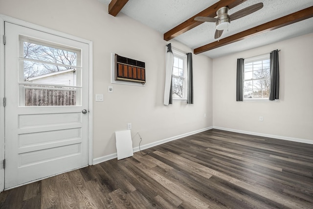 interior space featuring baseboards, dark wood finished floors, beamed ceiling, a textured ceiling, and a ceiling fan
