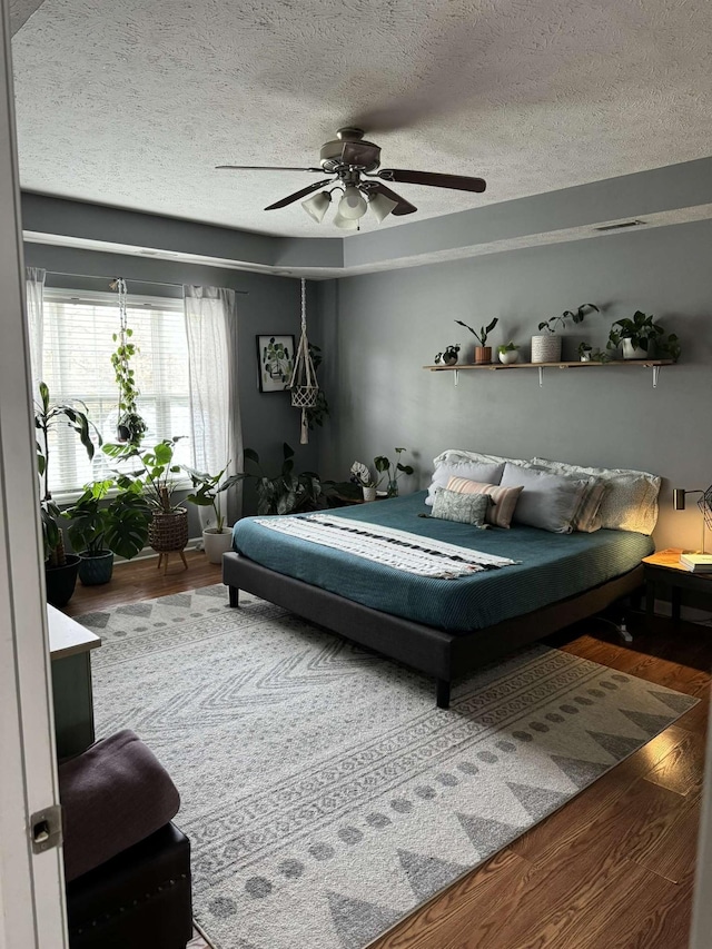 123 Hubbard St, Hohenwald, TN 38462 - bedroom featuring ceiling fan, wood finished floors, and a textured ceiling