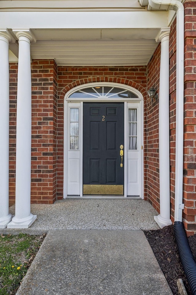 entrance to property with brick siding